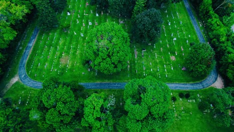 Top-View-over-Green-Graveyard-Filed-with-some-Trees-and-Graves-in-Mundelein,-Illinois,-USA