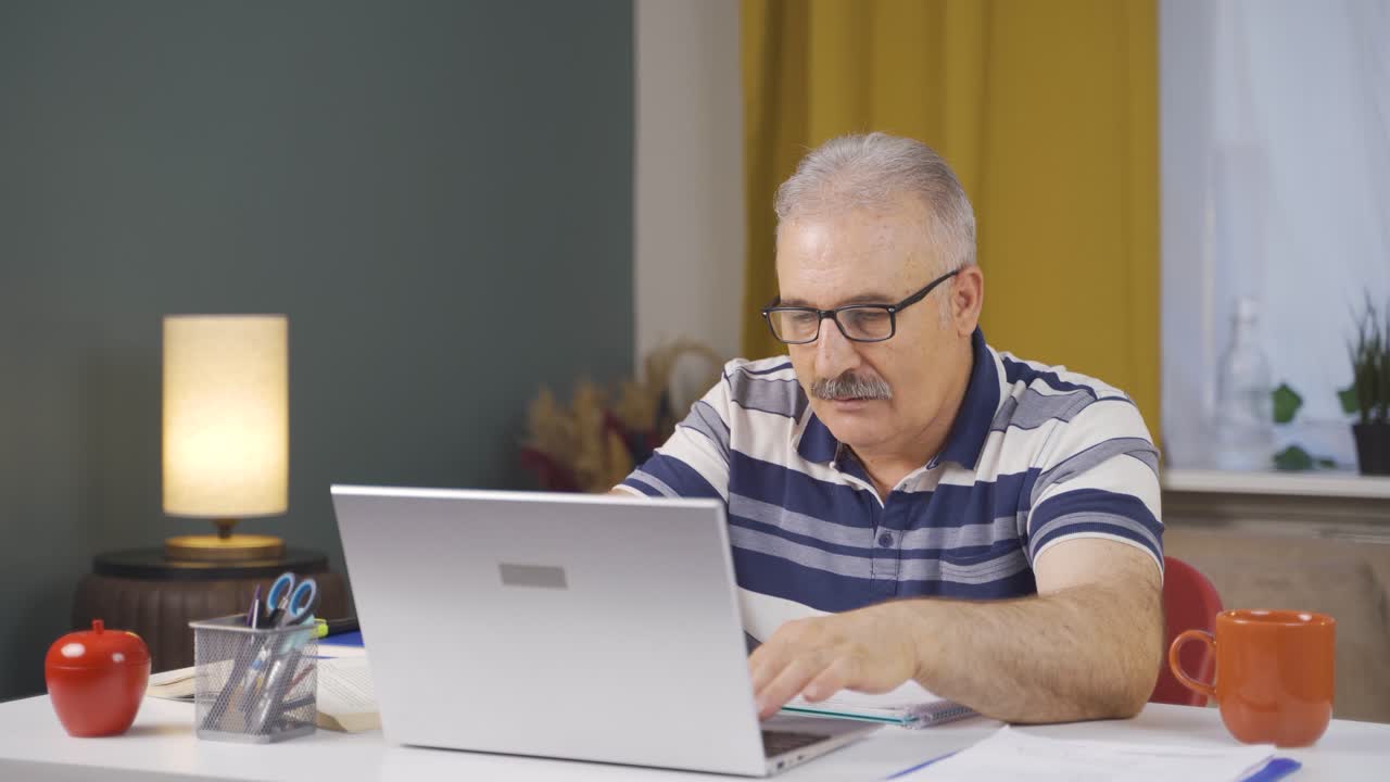 Home office worker old man experiencing joy.