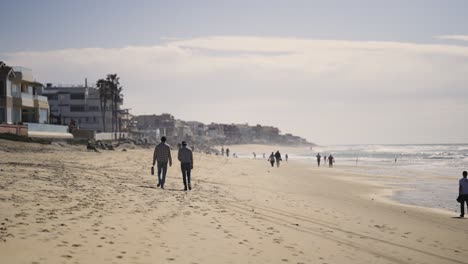 pacific beach california sunset with people walking down the beach