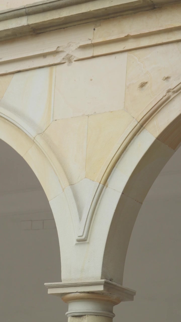 Vertical shot descends gently along an ornate stone column in historic Oviedo
