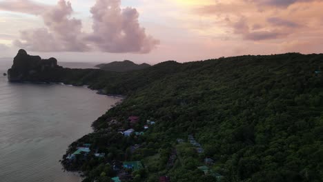 a partial aerial orbit capturing the serene forest on koh phi phi, thailand, bathed in the warm hues of sunset.