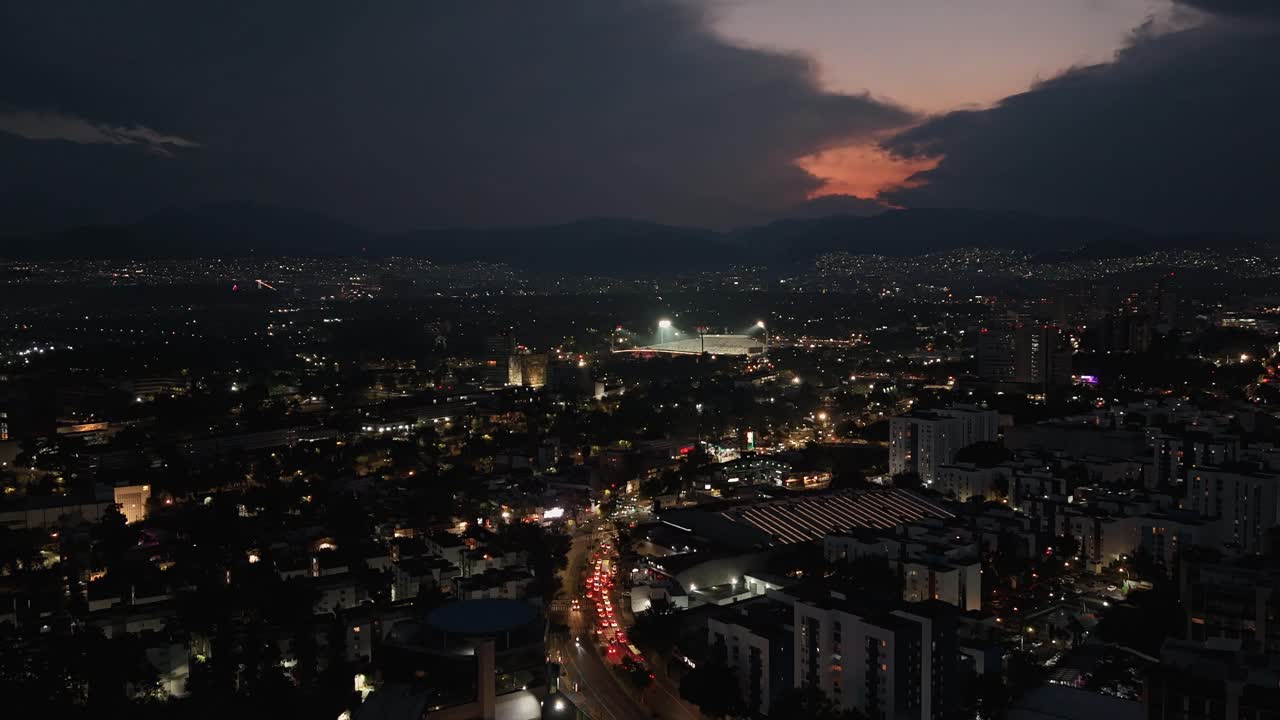Nighttime aerial hyperlapse over a brightly lit city