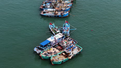 moored vietnamese fishing vessels, aerial orbit view