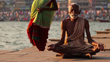 elderly man meditating by the ganges river