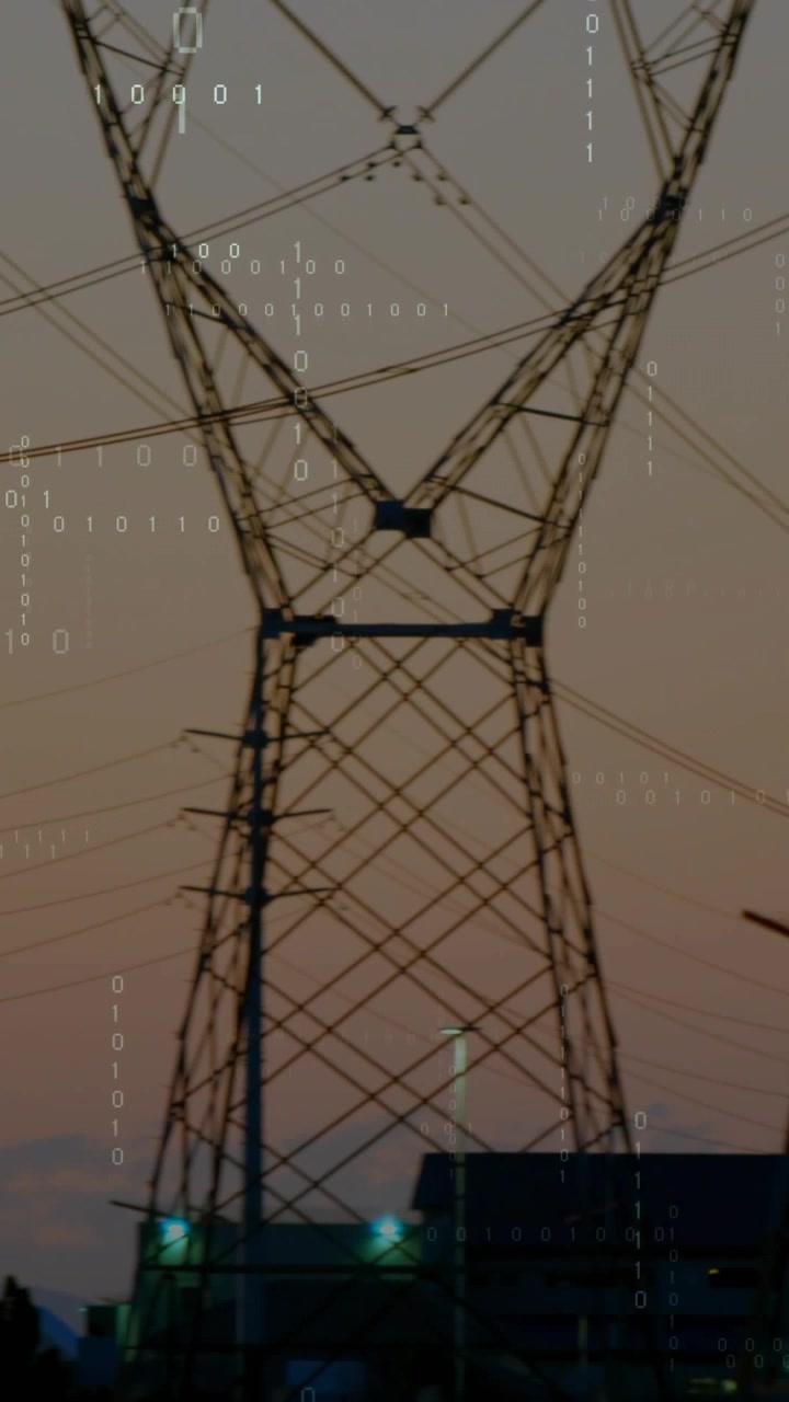 Vertical video: Camera panning right, poles and towers moving past roofs while binary showing grid