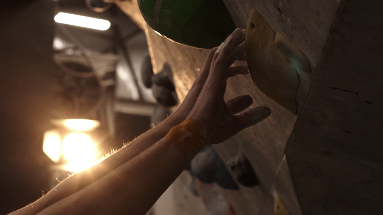 Person Climbing an Indoor Rock Wall