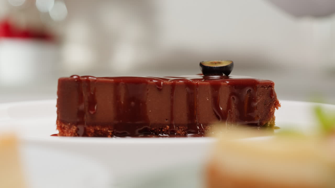 Chef Placing Blueberry Topping on Chocolate Cheesecake Slice
