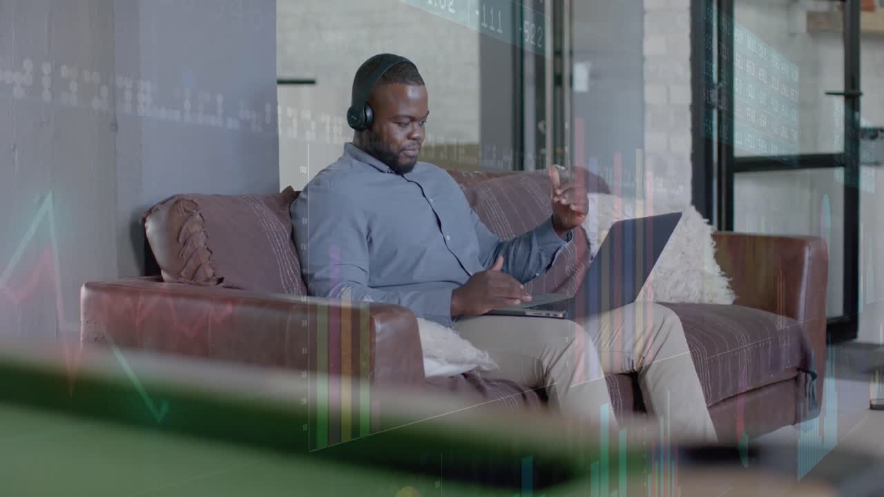 Graphs processing data over african american casual businessman having laptop video call