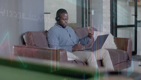 graphs processing data over african american casual businessman having laptop video call