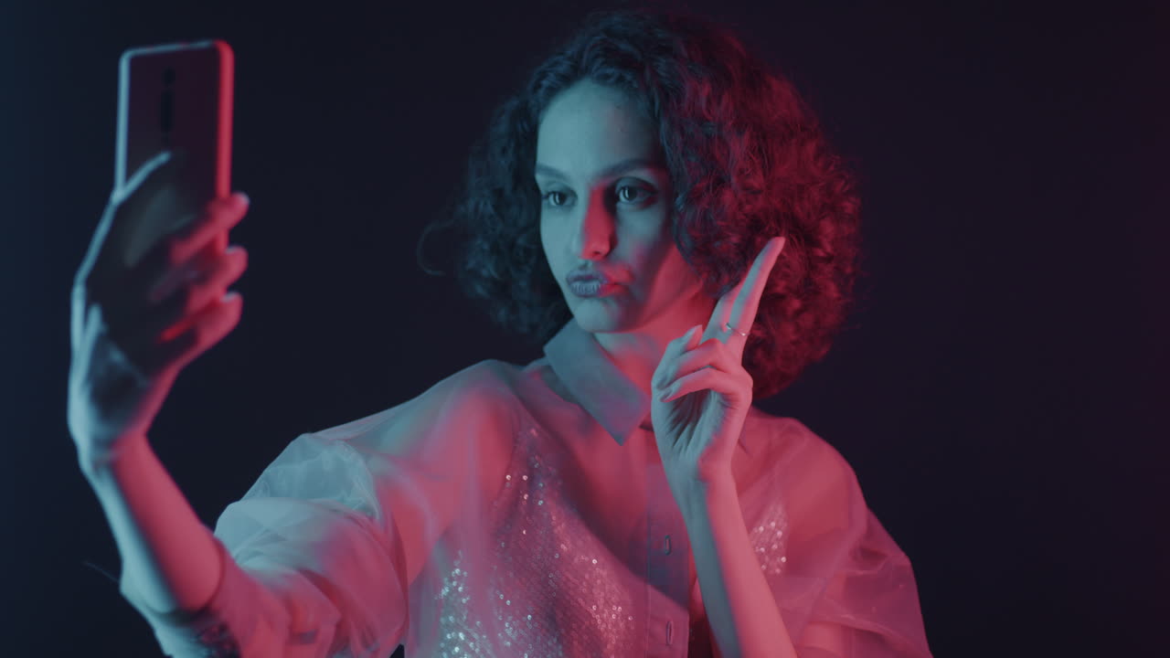 Young Woman Taking a Selfie in Neon Light