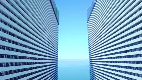 the drone flies between two buildings with glass windows.