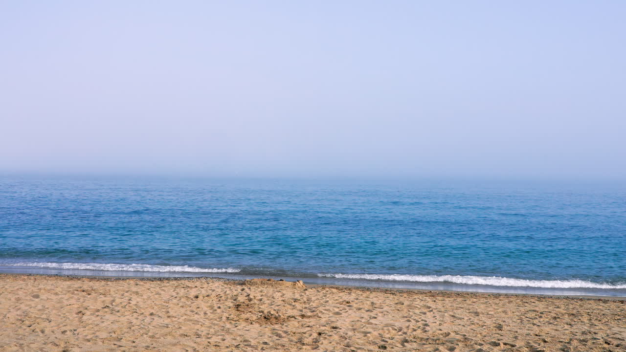 Empty beach with fog on the background