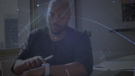 animation of networks of connections with icons over man using smartphone