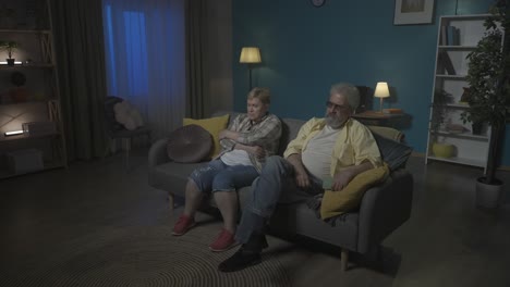 elderly couple arguing while one is using phone.