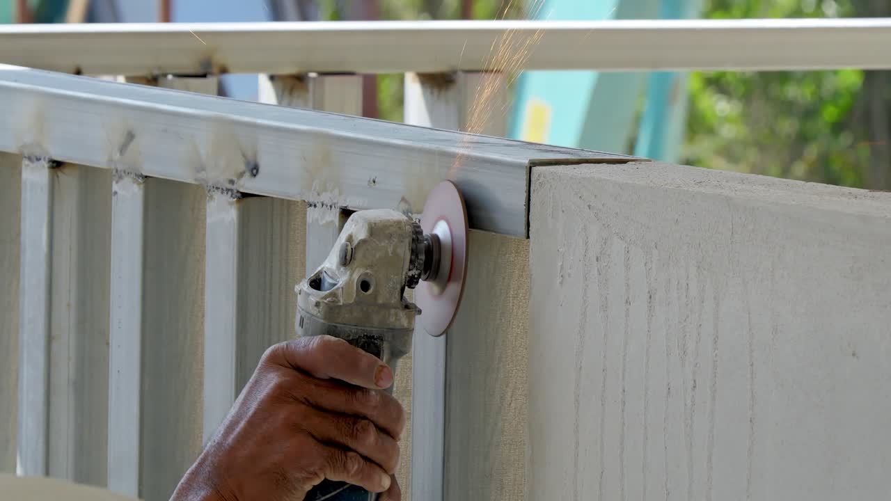 A craftsman expertly uses a power tool to enhance an outdoor space during a DIY renovation