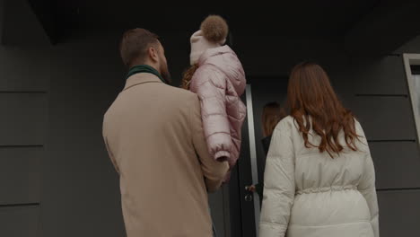 real estate agent showing house to family