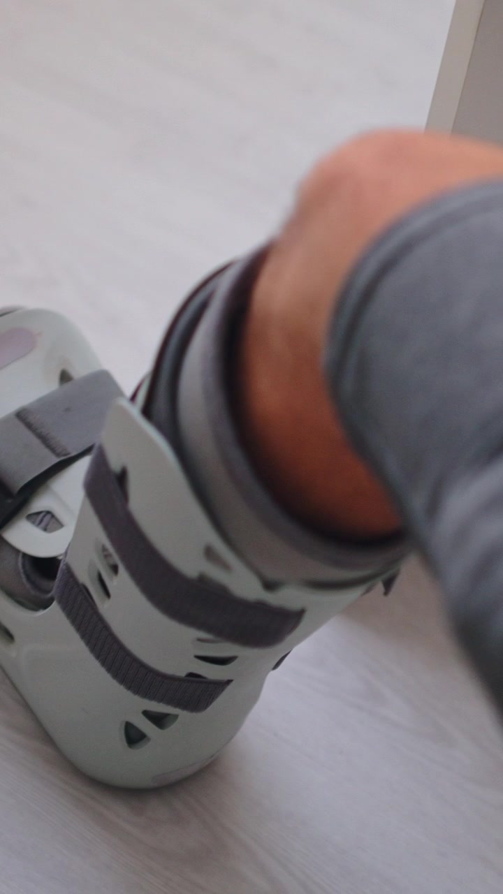 Person Wearing Orthopedic Walking Boot for Ankle Injury Recovery