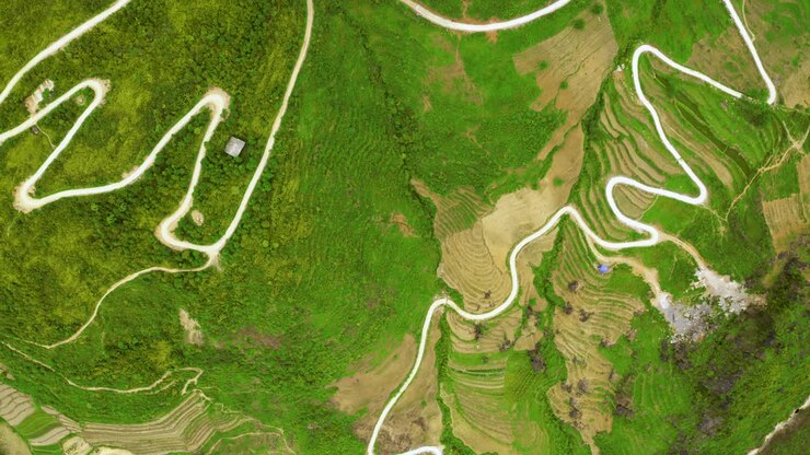 Top down shot of a winding road cut into the mountains of the gorgeous Ma Pi Leng Pass in northern Vietnam
