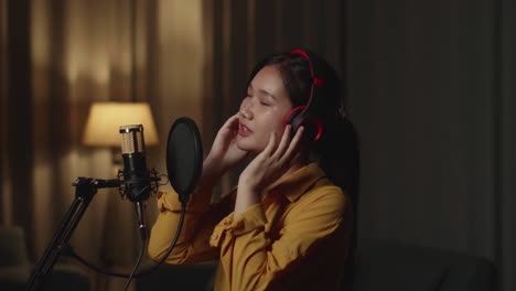 young woman singer singing in home studio