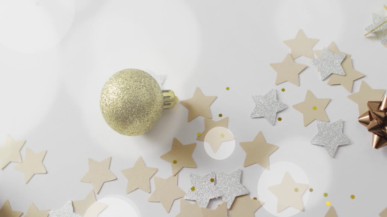 Animation of white spots over christmas decorations