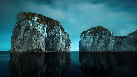 rocky cliffs in the ocean at sunny day