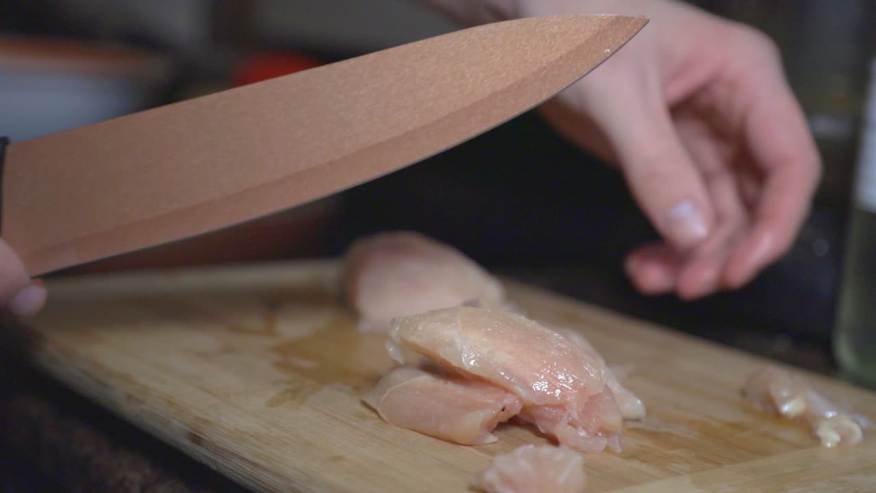 Cutting Chicken Meat On The Wooden Board - Close Up Shot