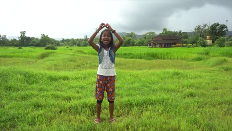 little girl dancing  near temple  farm malvan maharashtra