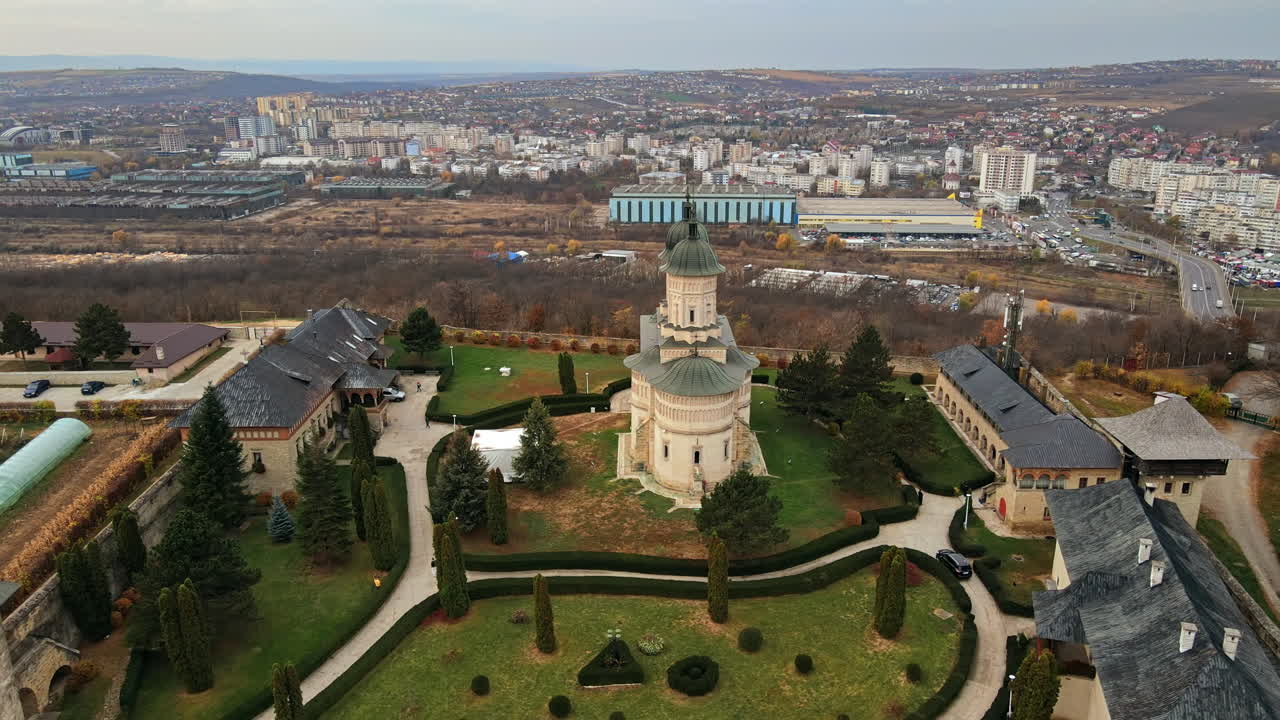 Aerial drone view of the Cetatuia Monastery in Iasi, Romania. Main church, inner court and buildings surrounded by ancient walls, city on the background