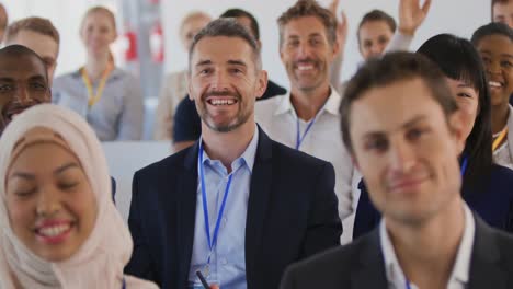 Audience-at-a-seminar-raising-hands-to-ask-questions