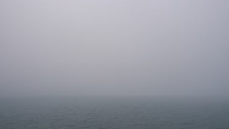 heavy fog over calm water surface