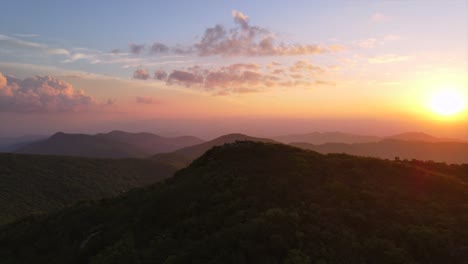 an excellent 180 aerial shot of the sun rising over the blue ridge mountains in north carolina