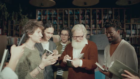 senior author signing books and posing for selfie with fans during meeting