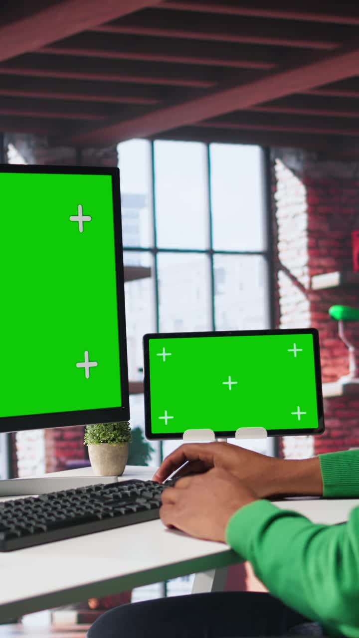 Vertical Video Black male worker in his loft using copy space PC to analyze sales reports