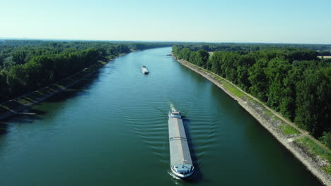 canal with barges and lush green banks