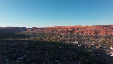 Pullback-drone-shot-flying-away-from-downtown-Moab,-Utah