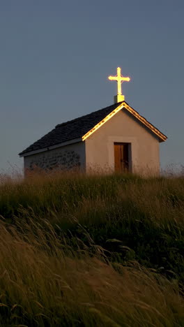 small chapel in a field at dusk