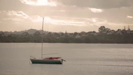 loopable footage of a boat floating on a river in the late afternoon