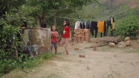 children playing near a water well in a vietnamese village