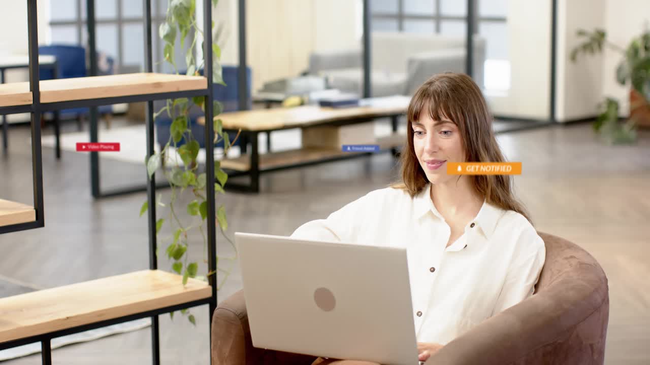 Woman with laptop hovering cursor, clicking play to reveal tech badges surrounding her, clearing