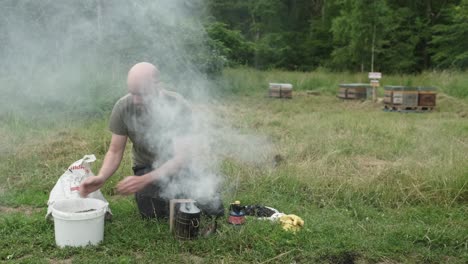 the smokehouse and smoker stands on a hive along with a frame for honey