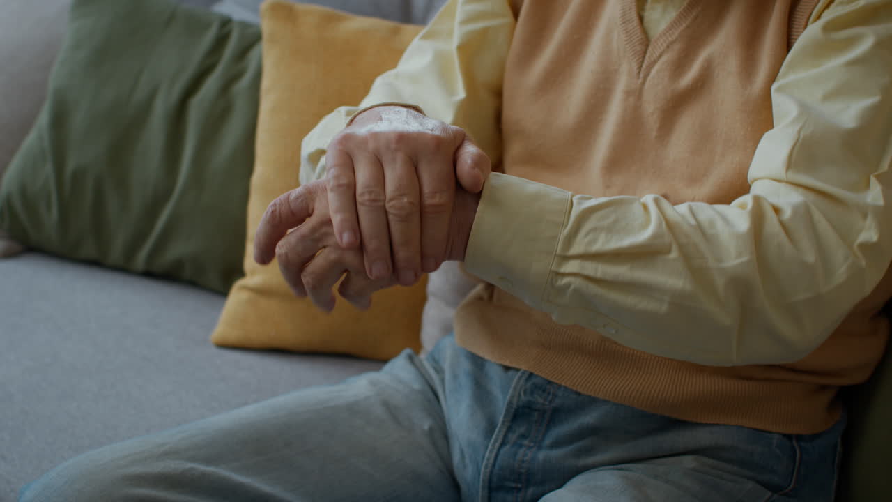 Elderly Man Experiencing Hand and Wrist Pain