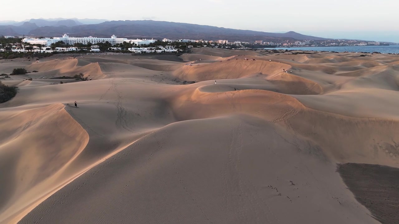 Maspalomas dunes extend toward coastal resorts and the Atlantic on Gran Canaria, aerial