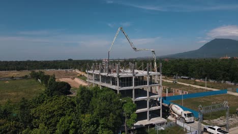 concrete mixer and large transport arm ensure that employees at the apartment complex under construction can work efficiently in bokor national park. drone lifting shot