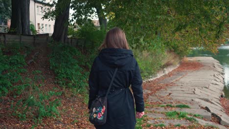 women walking in the garden with lake adjutant to walking pathway