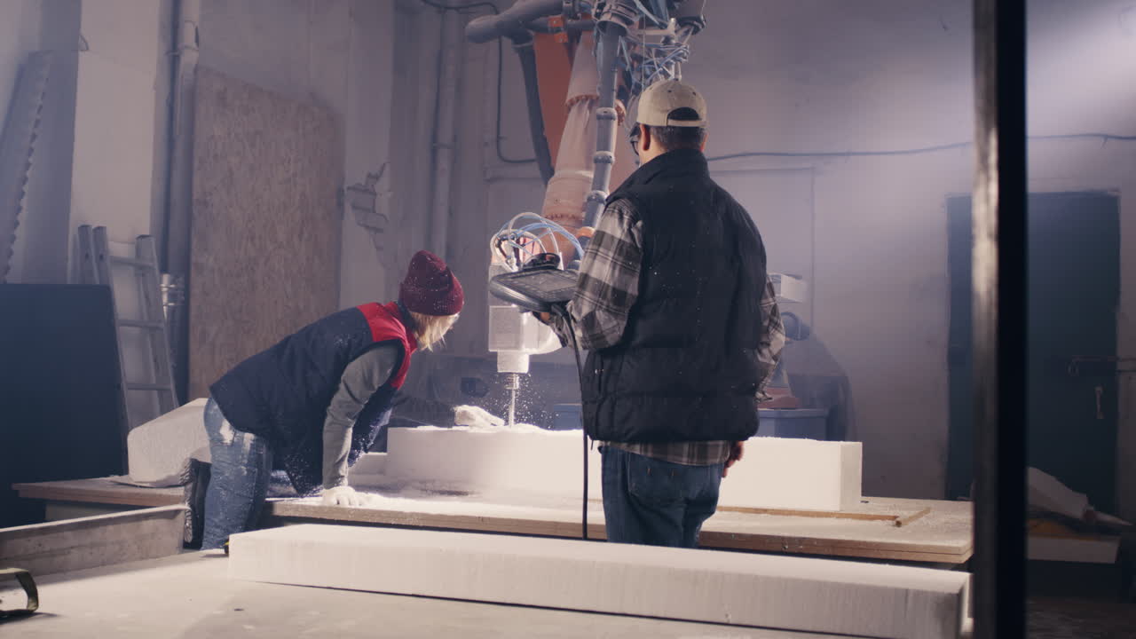 Two Workers Operating a CNC Foam Cutting Machine