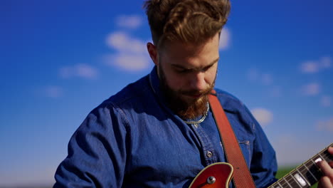 man playing guitar outdoors
