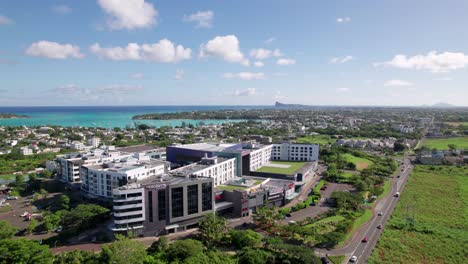 la croisette in mauritius, modern buildings alongside lush greenery, under clear blue skies, aerial view