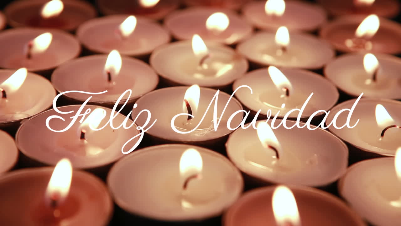 Feliz Navidad text animation over burning candles in festive arrangement
