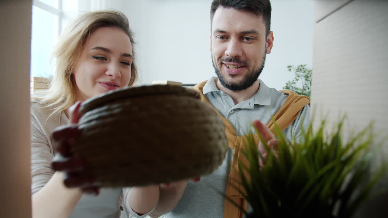Happy Couple Unpacking Moving Boxes