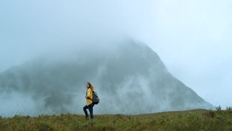 woman hiking in misty mountains